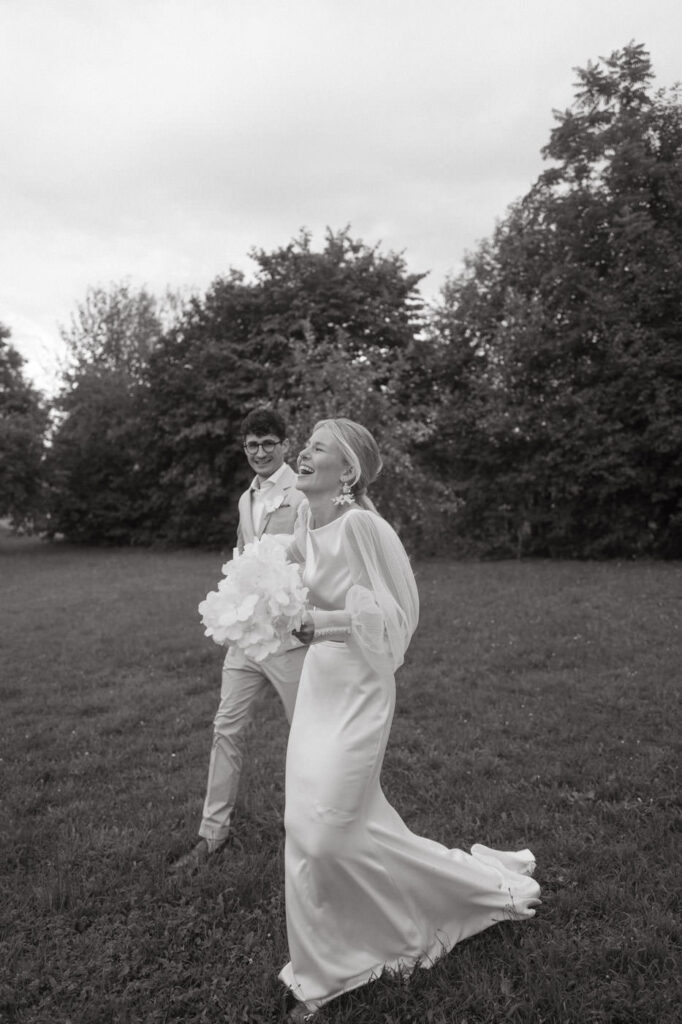 Bride and groom walking joyfully in a Mallorca wedding venue.