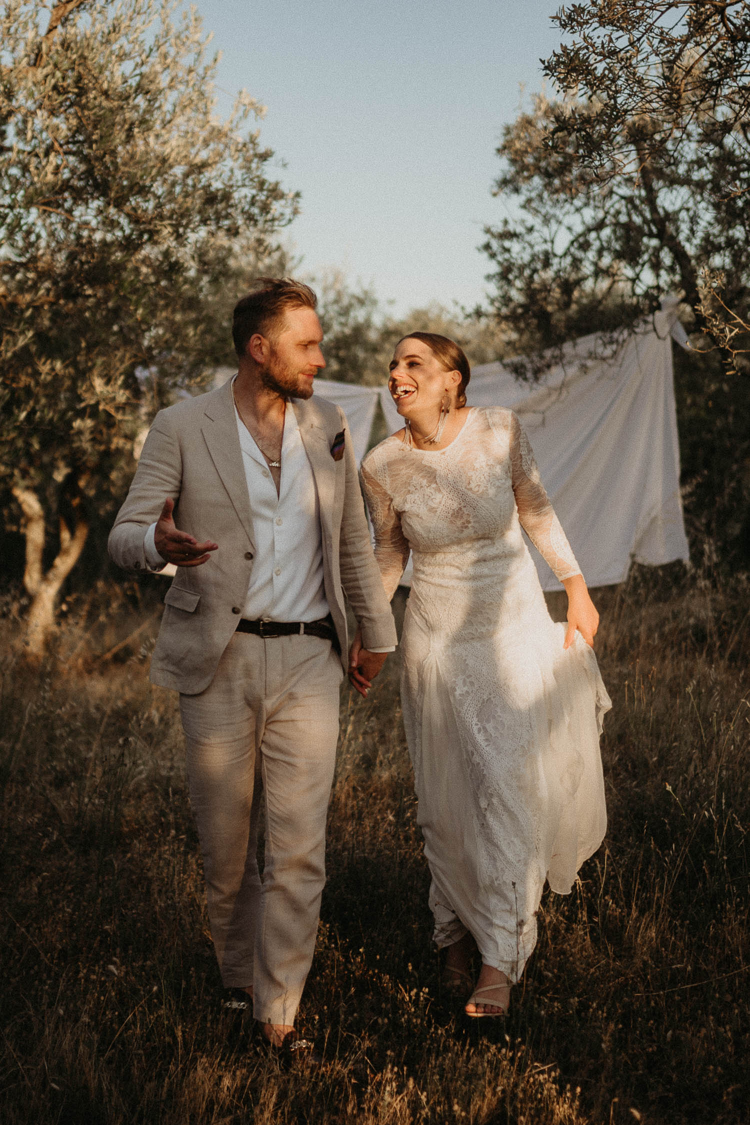 newlyweds walking through sunset in mallorca