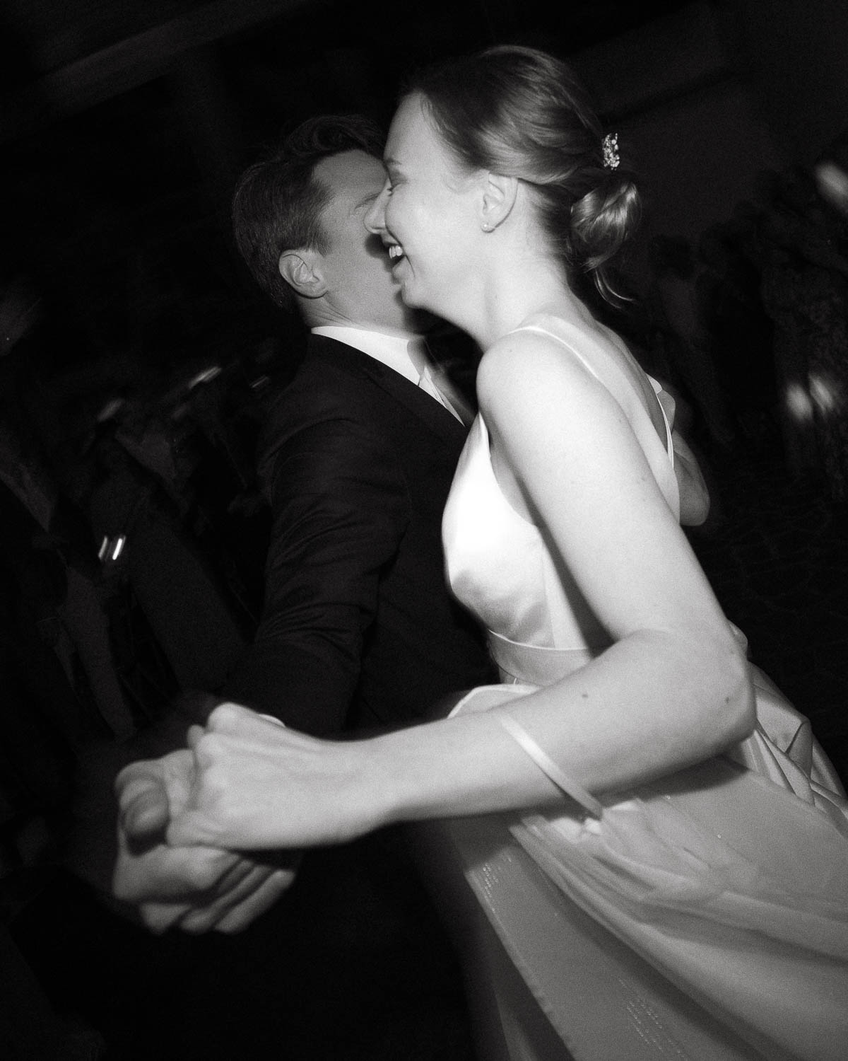 Bride and groom captured in motion during their first dance at a Tuscany wedding, photographed on film.