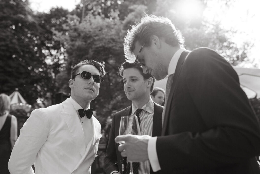 Groom stands together with his groomsmen at a wedding in Mallorca.