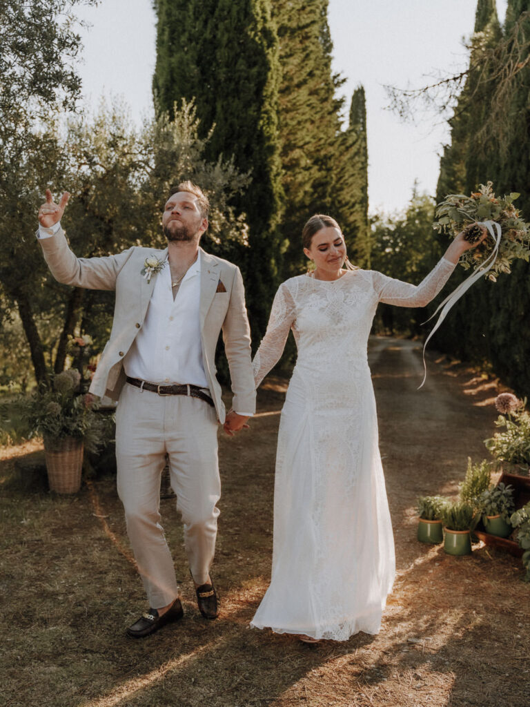 Bride and groom walking down an aisle in Tuscany.