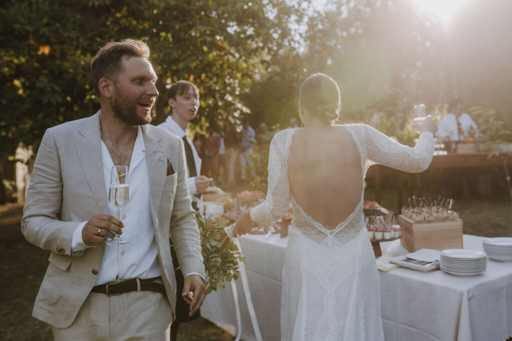 Bride and groom celebrating at sunset during wedding reception in Tuscany